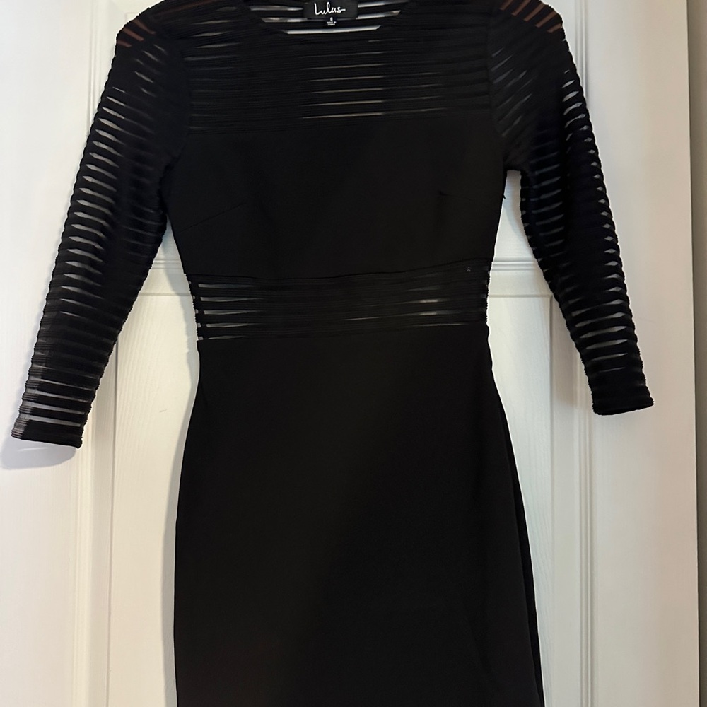 Black formal dress, see through detail on arms, top of chest, and waist belt